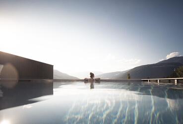 Infinity-Pool mit Blick auf die Berge bei Sonnenaufgang oder Sonnenuntergang; ei